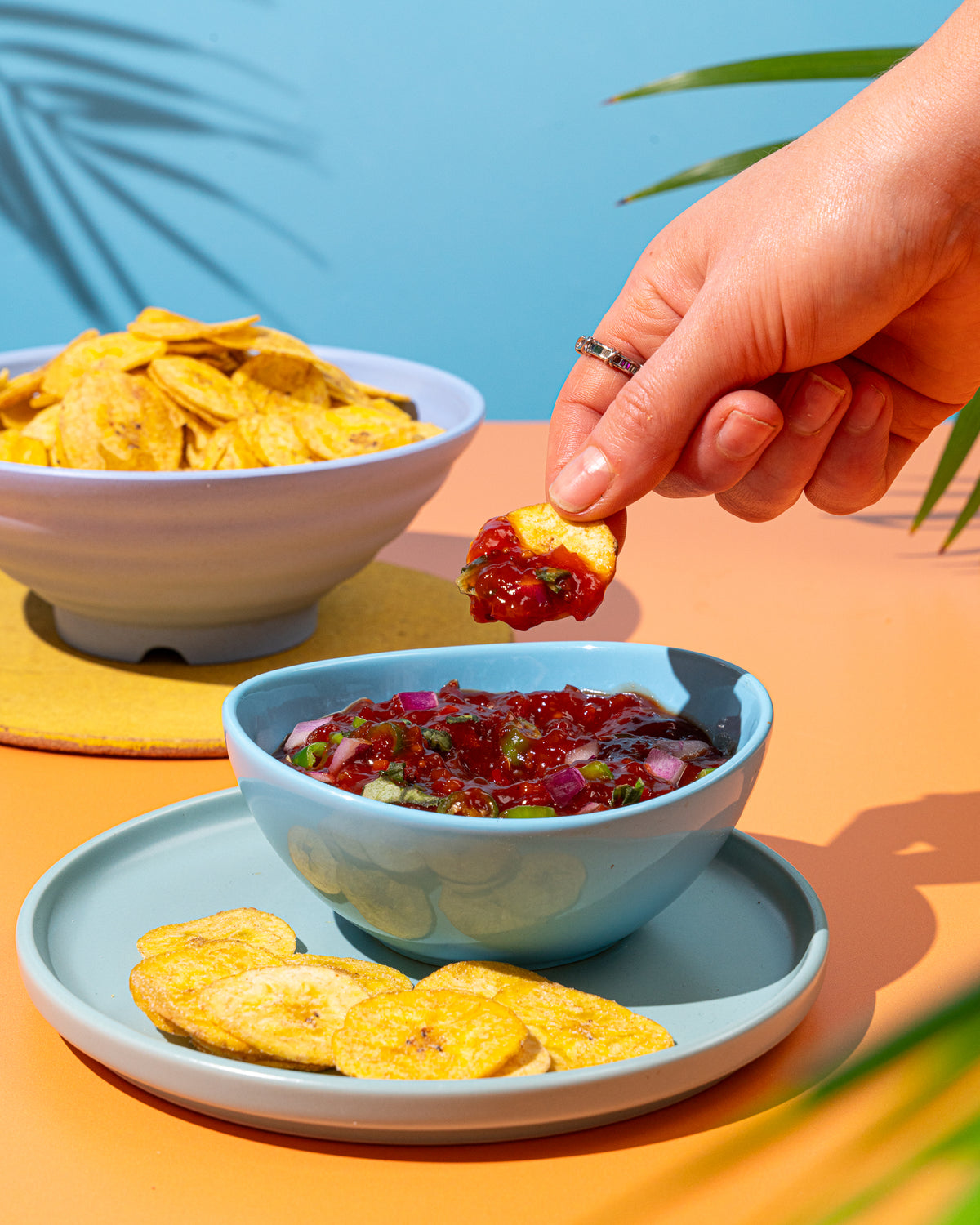 A plantain chip dipped in salsa
