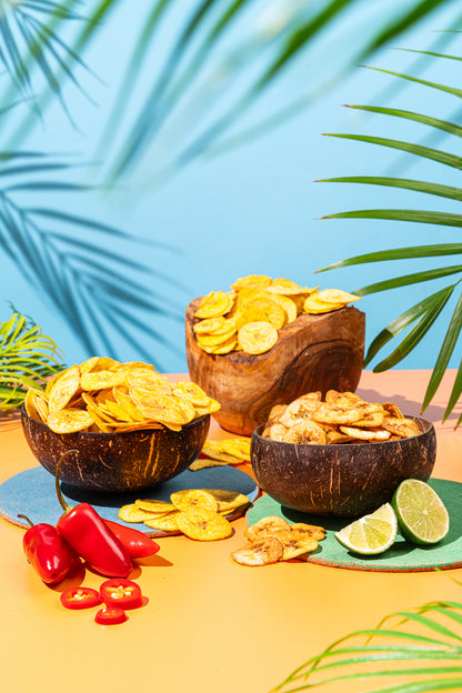 Three bowls of plantain chips with chillies and lime